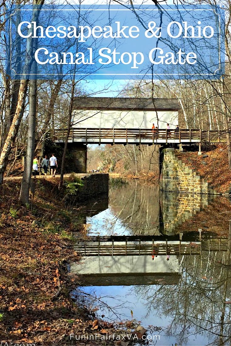 Hikers on the Chesapeake and Ohio Canal NP towpath in Maryland, pass what looks like a covered bridge but is actually an historic canal stop gate.