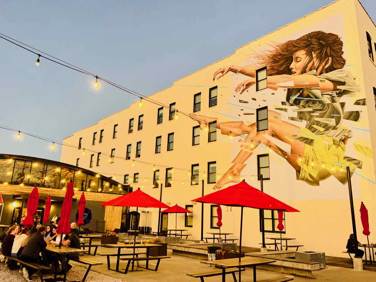 Outdoor tables and mural at Big Lick Brewing on Virginia's Blue Ridge Cheers Trail in Downtown Roanoke