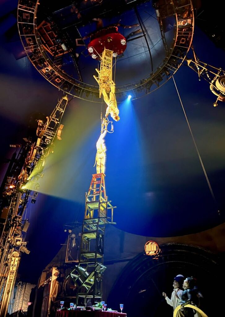 Two towers of chairs meet in Upside Down World Kurios