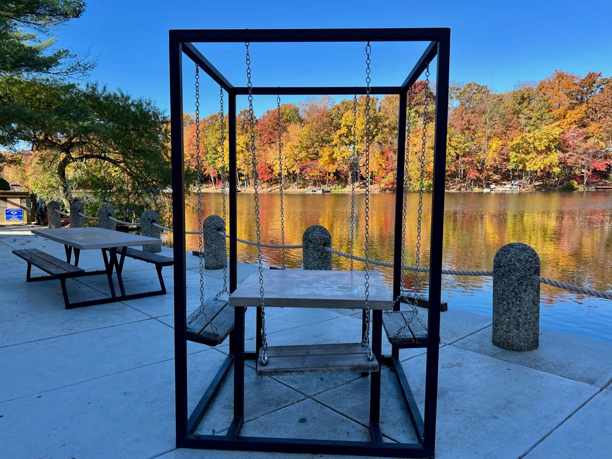 Picnic tables by Lake Thoreau with fall foliage view; perfect picnic spots in Northern VA.