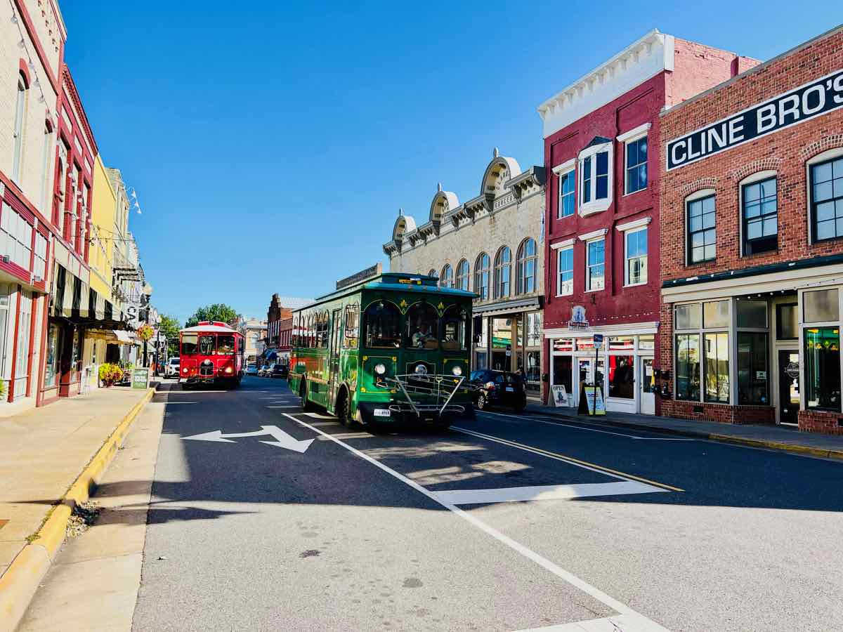 A trolley passes downtown shops and restaurants, some of the best things to do in Culpeper Virginia with trolley