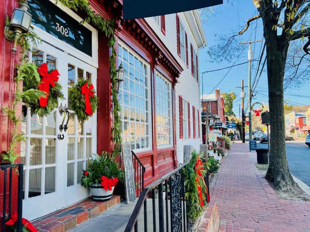 Festive wreaths and garlands decorating a store in Occoquan, one of the best Christmas towns near DC