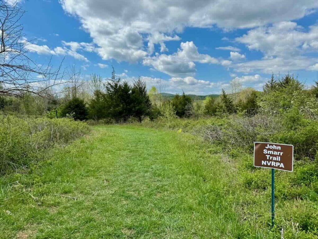 John Smarr Trail sign and meadow path at Gilberts Corner Park in Leesburg VA